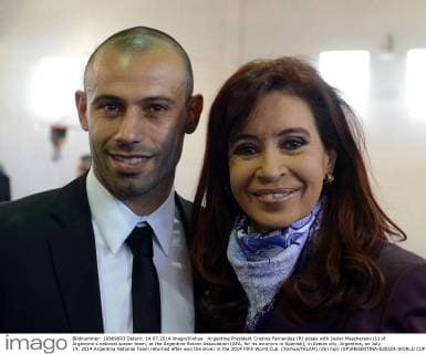Argentine President Cristina Fernandez (R) poses with Javier Mascherano (L) of Argentina s national soccer team, at the Argentine Soccer Association (AFA, for its acronym in Spanish), in Ezeiza city, Argentina, on July 14, 2014.Argentina National Team returned after won the silver in the 2014 FIFA World Cup. (Xinhua TELAM) (da) (sp) (SP)ARGENTINA-EZEIZA-WORLD CUP 2014-NATIONAL TEAM 