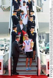 BERLIN, GERMANY - JULY 15: Sami Khedira, Thomas Müller, Bastian Schweinsteiger and Philipp Lahm come out of the aircraft on July 15, 2014 in Berlin, Germany. Local Caption Sami Khedira; Thomas Müller; Bastian Schweinsteiger; Philipp Lahm