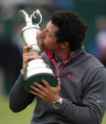 Nprthern Ireland s Rory McIlroy kisses the Claret jug after winning the 2014 Open Golf Championships in Hoylake on July 20, 2014.  LON2014072002