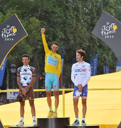 Astana team rider Vincenzo Nibali (C) of Italy, AG2R-La Mondiale team rider Jean-Christophe Peraud (L) of France and FDJ.fr team rider Thibaut Pinot of France react on the podium after the 137.5 km final stage of the 2014 Tour de France in Paris, France, on July 27, 2014. (Xinhua Chen Xiaowei) (SP)FRANCE-PARIS-TOUR DE FRANCE 