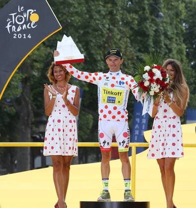 Rafal Majka of Poland arrives on the presentation podium after winning the jersey for best mountain climber of the Tour de France in Paris on July 27, 2014.  PAR201407127733