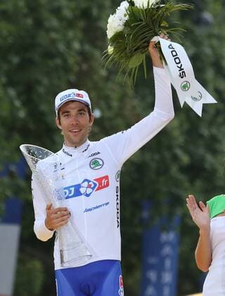 France s Thibaut Pinot arrives on the presentation podium after winning the white jersey for best young rider of the Tour de France in Paris on July 27, 2014.  PAR201407127735