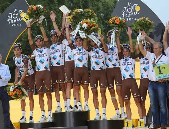 France s AG2R La Mondiale cycling team celebrate on the presentation podium after winning the team award of the Tour de France in Paris on July 27, 2014.  PAR201407127741