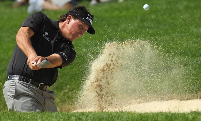 July 31, 2014 - Akron, OH, USA - Phil Mickelson hits out of a sand trap on the 15th hole during the first round in the WGC-Bridgestone Invitational at Firestone Country Club in Akron, Ohio, on Thursday, July 31, 2014. WGC-Bridgestone Invitational, first round - ZUMAm67