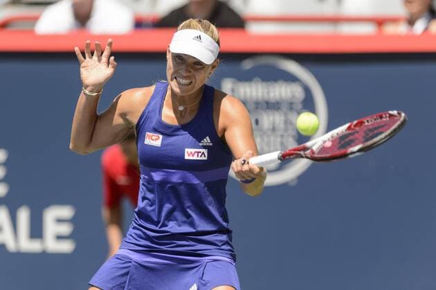 06 August 2014: Angelique Kerber of Germany hits a return during the second round of the Rogers Cup Presented by National Bank at Uniprix Stadium in Montreal, Quebec, Canada. TENNIS: AUG 06 Rogers Cup - woman Montreal Icon140806002 EDITORIAL USE ONLY