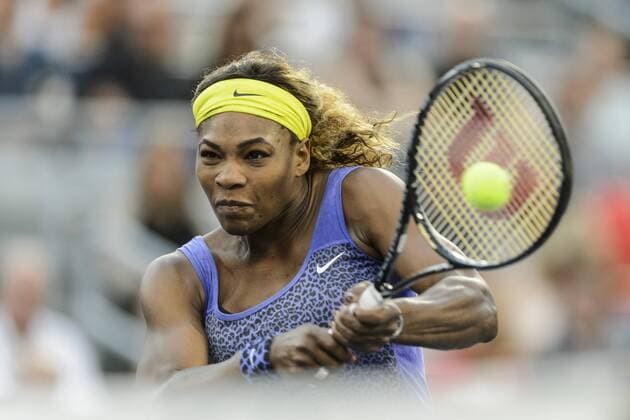 06 August 2014: Serena Williams of the United States rushes the net and hits a return during the second round of the Rogers Cup Presented by National Bank at Uniprix Stadium in Montreal, Quebec, Canada. TENNIS: AUG 06 Rogers Cup - woman Montreal Icon140806031 EDITORIAL USE ONLY