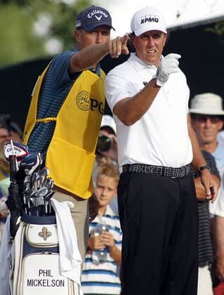 Phil Mickelson (R) and caddie Jim Mackay gesture to where they think Mickelson s second shot should be hit on the 10th hole during the first round of the 96th PGA Golf Herren Championship at Valhalla Country Club on August 7, 2014 in Louisville, Kentucky.  LOU2014080710