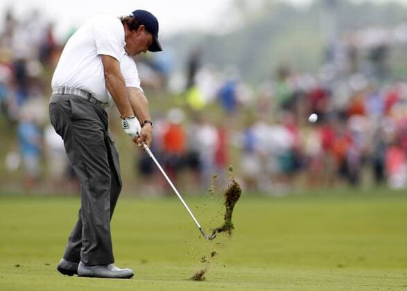 Phil Mickelson, of the United States, hits his approach shot to the first green during the third round of the 96th PGA Golf Herren Championship at Valhalla Country Club on August 9, 2014 in Louisville, Kentucky. Mickelson shot a four under par 67 and trails leader Rory McIlroy by three strokes entering Sunday s final round.  LOU2014080915