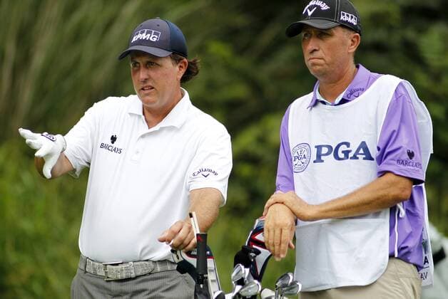 Phil Mickelson, of the United States, gestures to his caddie Jim McKay as they talk on the second tee during the third round of the 96th PGA Golf Herren Championship at Valhalla Country Club on August 9, 2014 in Louisville, Kentucky. Mickelson shot a four under par 67 and trails leader Rory McIlroy by three strokes entering Sunday s final round.  LOU2014080918