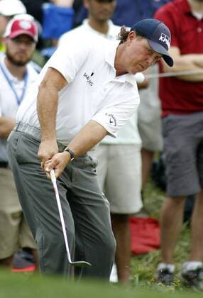 Phil Mickelson, of the United States, hits a chip shot onto the first green during the third round of the 96th PGA Golf Herren Championship at Valhalla Country Club on August 9, 2014 in Louisville, Kentucky. Mickelson shot a four under par 67 and trails leader Rory McIlroy by three strokes entering Sunday s final round.  LOU2014080919