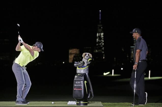 Tiger Woods watches Rory McIlroy hit an iron with One World Trade Center in the background at the launch of the new Nike Vapor Iron Franchise at Liberty National Golf Club in Jersey City, NJ on August 18, 2014. The Vapor Iron Franchise consists of 3 sets of golf club irons; The Vapor Pro, Vapor Pro Combo and Vapor Speed.  NYP20140818109