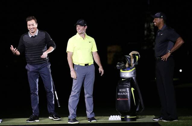 Jimmy Fallon, Rory McIlroy and Tiger Woods stand on the stage at the launch of the new Nike Vapor Iron Franchise at Liberty National Golf Club in Jersey City, NJ on August 18, 2014. The Vapor Iron Franchise consists of 3 sets of golf club irons; The Vapor Pro, Vapor Pro Combo and Vapor Speed.  NYP20140818122