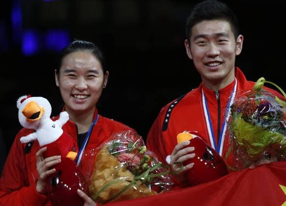 COPENHAGEN -- Bronze medalists Liu Cheng and Bao Yixin(L) of China smile during the awarding ceremony for the Mixed Doubles Final on Day 7 of Li Ning BWF World Championships 2014 at Ballerup Super Arena in Copenhagen, Denmark on Aug. 31, 2014. 