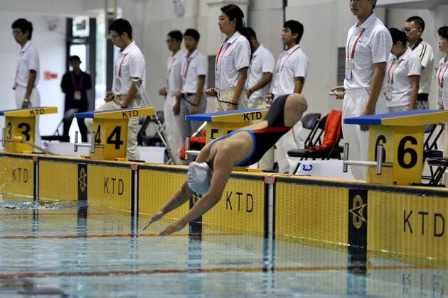 KUNMING, CHINA - SEPTEMBER 01: (CHINA OUT) Handicapped Qian Hongyan, known as the Basketball girl , wins the the Women s 100m Breaststroke S5 Final gold medal during the 10th Yunnan Provincial Paralympic Games on September 1, 2014 in Kunming, Yunnan Province of China. Qian Hongyan was born in Luliang County of Yunnan Province in 1996. She lost her lower body in a car accident in 2000 when she was just 4 years old. She then used to walk with half of a basketball and two wooden handle bars to go to school. After Qian Hongyan s story was reported, China Rehabilitation Research Center decided to help her fit artificial limbs for free. Qian also took rehabilitating treatment in the rehabilitation center for 3 months in 2005. In 2007, she joined the South of the Clouds Swimming Club to learn to swim and dreams of competing at the London 2012 Paralympic Games. In 2010, She won three gold medals in the 13rd Yunnan Province Games and three silver medals in the Zhejiang National Swimming Championships for the Disabled. But she lost the opportunity to attend the London 2012 Paralympic Games, as her best record is the bronze medal in the SB6 100m Breaststroke at the 2011 National Games for the Disabled. I really want to attend the London Paralympic Games, Qian Hongyan said, but it s okay, I am very young, so I have a lot of opportunities, I am struggling for the Rio 2016 Paralympic Games, I will be there. CFP19086719