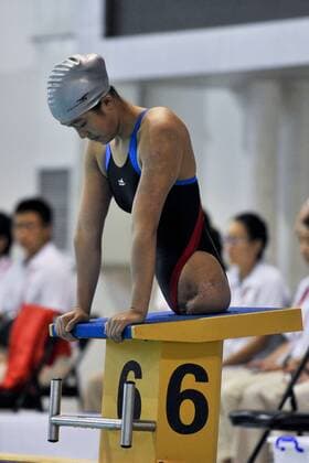 KUNMING, CHINA - SEPTEMBER 01: (CHINA OUT) Handicapped Qian Hongyan, known as the Basketball girl , wins the the Women s 100m Breaststroke S5 Final gold medal during the 10th Yunnan Provincial Paralympic Games on September 1, 2014 in Kunming, Yunnan Province of China. Qian Hongyan was born in Luliang County of Yunnan Province in 1996. She lost her lower body in a car accident in 2000 when she was just 4 years old. She then used to walk with half of a basketball and two wooden handle bars to go to school. After Qian Hongyan s story was reported, China Rehabilitation Research Center decided to help her fit artificial limbs for free. Qian also took rehabilitating treatment in the rehabilitation center for 3 months in 2005. In 2007, she joined the South of the Clouds Swimming Club to learn to swim and dreams of competing at the London 2012 Paralympic Games. In 2010, She won three gold medals in the 13rd Yunnan Province Games and three silver medals in the Zhejiang National Swimming Championships for the Disabled. But she lost the opportunity to attend the London 2012 Paralympic Games, as her best record is the bronze medal in the SB6 100m Breaststroke at the 2011 National Games for the Disabled. I really want to attend the London Paralympic Games, Qian Hongyan said, but it s okay, I am very young, so I have a lot of opportunities, I am struggling for the Rio 2016 Paralympic Games, I will be there. CFP19086720
