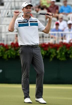 Co-leader Chris Kirk bites his club after missing a birdie attempt on No. 18 but he cards a par and a 4-under score that ties him with Billy Horschel during the first round of the PGA Golf Herren Tour Championship on September 11, 2014 at East Lake Golf Club in Atlanta.  AJP2014091138