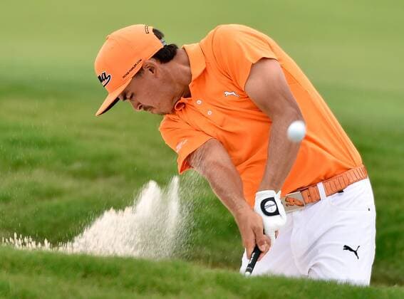 Rickie Fowler blasts from the fairway bunker at No. 17 where he scores a par and later finishes 5-under, six strokes off the lead, during the final round of the PGA Golf Herren Tour Championship at East Lake Golf Club on September 14, 2014, in Atlanta.  AJP2014091430