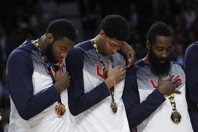 United State s James Harden, Anthony Davis and Andre Drummond listen to the national anthem with the golden medal during FIBA Basketball World Cup 2014 final award ceremony in Madrid, September 14, 2014.  (2014091422993)