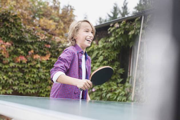 Germany, Leipzig, Boy playing table tennis, smiling model released  BMF000632