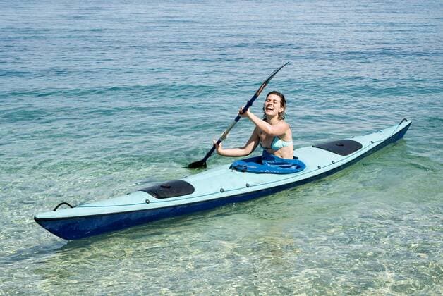 Greece, Ithaca, Woman kayaking model released  MUF00778