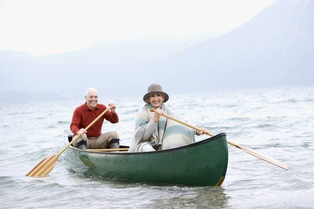 Germany, Bavaria, Walchensee, Senior couple rowing boat on lake model released  WESTF10214