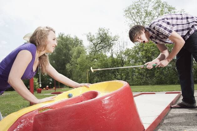 Germany, Bavaria, Ammersee, Young couple playing mini golf model released  WESTF12198