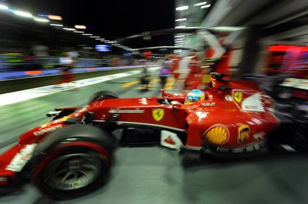 Ferrari driver Fernando Alonso drives out of the team garage during the second practice session at the Singapore F1 Night Race on Sept. 19, 2014. Singapore F1 Night Race held 2 practice sessions at the Marina Bay Street Circuit in Singapore. ) (SP)SINGAPORE-F1-PRACTICE ThenxChihxWey 