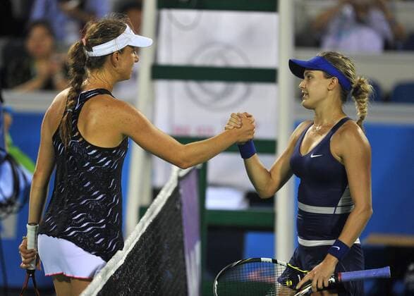 Canada s Eugenie Bouchard (R) shakes hands with Mona Barthel of Germany during their match at the WTA Tennis Damen Wuhan Open tennis tournament in Wuhan capital of central China s Hubei Province, on Sept. 23, 2014. ) (djj) (SP)CHINA-WUHAN-TENNIS-WUHAN OPEN-BOUCHARD XiaoxYijiu 