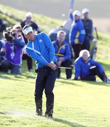 Europe s Ian Poulter chips the ball during the morning fourball match against USA s Spieth and Reed on the first day of the 2014 Ryder Cup in Gleneagles,Scotland on September 26, 2014. USA s Spieth and Reed won the match 5 and 4.  LON2014092614
