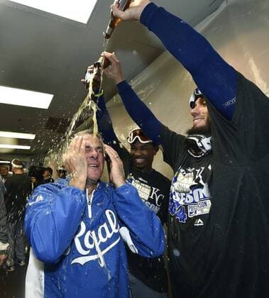 Sept. 26, 2014 - Chicago, IL, USA - Kansas City Royals general manager Dayton Moore is doused in the celebration by James Shields and Terrance Gore after the team clinches a wild card spot following a 3-1 win against the Chicago White Sox on Friday, Sept. 26, 2014, at U.S. Cellular Field in Chicago. The postseason berth is the Royals first in 29 years. Kansas City at Chicago White Sox - ZUMAm67_