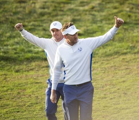 27.09.2014. Gleneagles, Auchterarder, Perthshire, Scotland. The Ryder Cup, Day 2. Ian Poulter and Rory McIlroy (EUR) acknowledge the crowd as they walk on to the first tee for Saturday Fourballs. xStephenxBartholomewx  ActionPlus11563542