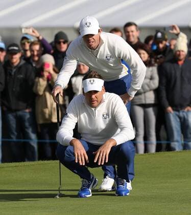 Europe s Rory McIlroy ( Mc Ilroy ) and ian Poulter line up a putt in the morning fourball match against USA s Rickie Fowler and Jimmy Walker on the second day of the 2014 Ryder Cup in Gleneagles,Scotland on September 27, 2014.The match was halved.  LON2014092718
