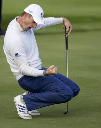 Europe s Justin Rose celebrates a putt against USA s Bubba Watson and Matt Kuchar in the morning fourball match on the second day of the 2014 Ryder Cup in Gleneagles,Scotland on September 27, 2014.The match was won 3 and 2.  LON2014092735