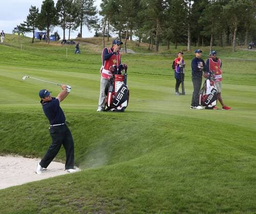 USA s Patrick Reed hits out of the bunker in the afternoon foursomes match against Europe s Martin Kaymer and Justin Rose on the second day of the 2014 Ryder Cup in Gleneagles,Scotland on September 27, 2014.  LON2014092738