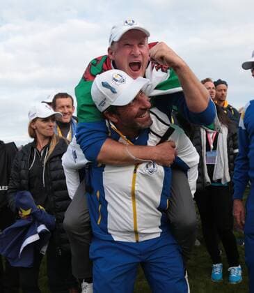 Europe s Jamie Donaldson jumps on Jose Maria Olazabal s back after securing the final point to beat USA on the final day of the 2014 Ryder Cup in Gleneagles,Scotland on September 28, 2014.  LON2014092848