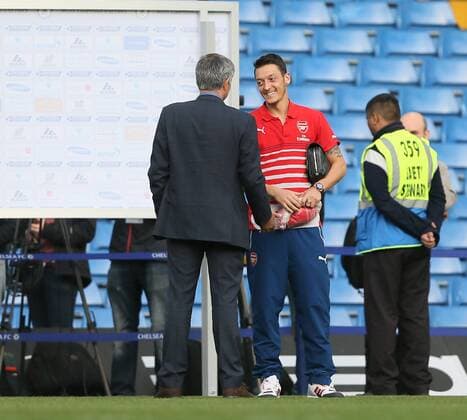 Chelsea s Jose Mourinho chats with Arsenal s Mesut Ozil after the match - Barclays Premier League - Chelsea Vs Arsenal - Stamford Bridge - England - 5th October 2014 - EDITORIAL USE ONLY. No use with unauthorised audio, video, data, fixture lists, club league logos or live services. Online in-match use limited to 120 images, no video emulation. No use in betting, games or single club league player publications.