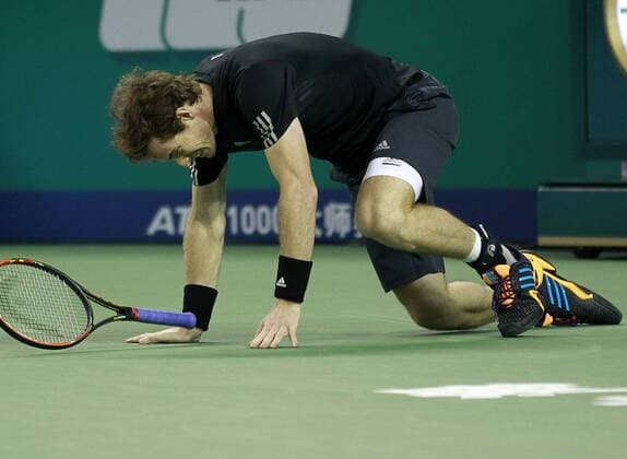 Britain s Andy Murray trippes during the men s singles match at the Shanghai Masters tennis tournament in Shanghai, east China, on Oct. 7, 2014. ) (SP)CHINA-SHANGHAI-TENNIS-MASTERS DingxTing 