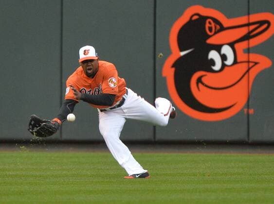 Baltimore Orioles LF Alejandro De Aza mises a catch on a ball hit by Kansas City Royals Eric Hosmer in the third inning of game 2 of the American League Championship Series at Orioles Park at Camden Yards in Baltimore, Maryland on October 11, 2014.  BAL20141011206