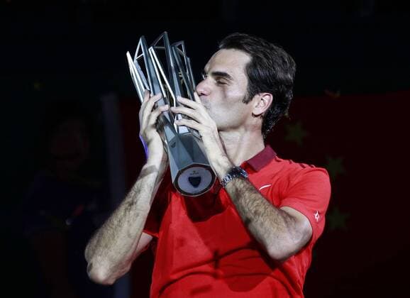 Roger Federer of Switzerland kisses the trophy after the men s singles final match at the Shanghai Masters tennis tournament in Shanghai, east China, Oct. 12, 2014. (SP)CHINA-SHANGHAI-TENNIS-ATP-SHANGHAI MASTERS (CN) DingxTing 
