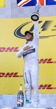 SOCHI, RUSSIA. OCTOBER 12, 2014. Mercedes Lewis Hamilton of the UK raises his trophy during an awards ceremony as he wins the 2014 Formula One Russian Grand Prix at the Sochi Autodrom racing circuit. Sergei Savostyanov TASS  RE151AB1