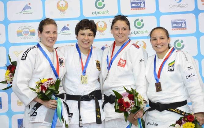 Gold medallist Laura Vargas Koch of Germany (2nd L), silver medallist Bernadette Graf of Austria (1st L) pose for photos during the award ceremony for Women s -70KG match at Tashkent 2014 Judo Grand Prix in Tashkent, Uzbekistan, on Oct. 17, 2014. ) (SP)UZBEKISTAN-TASHKENT-JUDO GRAND PRIX Sadat 
