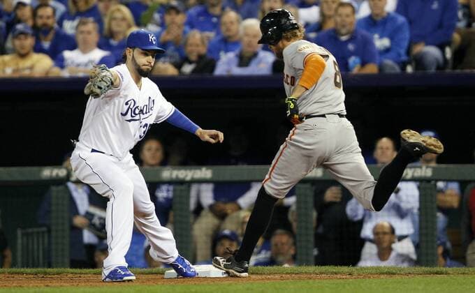 Kansas City Royals first baseman Eric Hosmer (L) makes the put out on San Francisco Giants right fielder Hunter Pence during the fifth inning of game 1 of the World Series at Kaufman Stadium in Kansas City, Missouri on October 21, 2014.  KCP2014102155