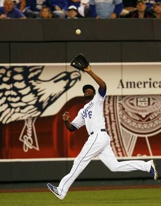 Kansas City Royals center fielder Lorenzo Cain chases down fly ball from San Francisco Giants Juan Perez during the sixth inning of game 1 of the World Series at Kaufman Stadium in Kansas City, Missouri on October 21, 2014.  KCP2014102156