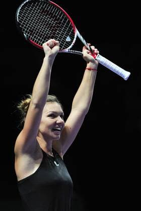 Romania s Simona Halep celebrates after winning the round robin match of the WTA Tennis Damen Finals of the U.S. at Singapore Indoor Stadium, Oct. 22, 2014. ThenxChihxWey 