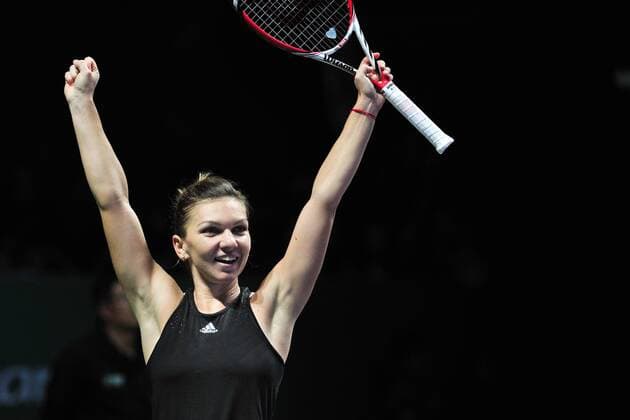 Romania s Simona Halep celebrates after winning the round robin match of the WTA Tennis Damen Finals of the U.S. at Singapore Indoor Stadium, Oct. 22, 2014. ThenxChihxWey 