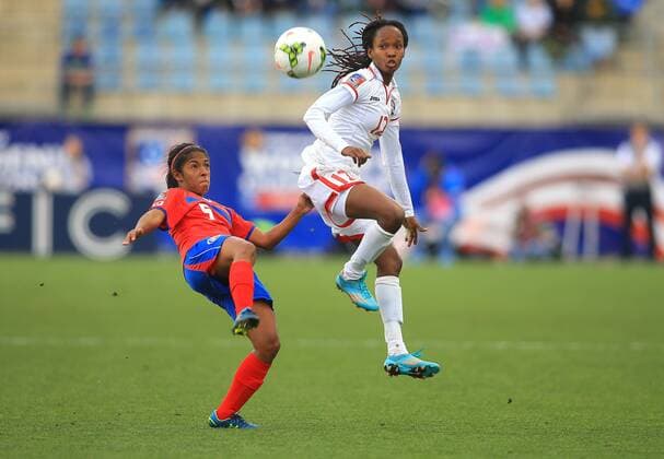 October 24 2014: Diana Saenz (5) of Costa Rica boots the ball away from Ahkeela Mollon (12) of Trinidad & Tobago during a CONCACAF Women s World Cup semi-final qualifier at PPL Park, in Chester PA. SOCCER: OCT 24 CONCACAF Women s World Cup Qualifier - Costa Rica v Trinidad & Tobago Icon25514102401 EDITORIAL USE ONLY