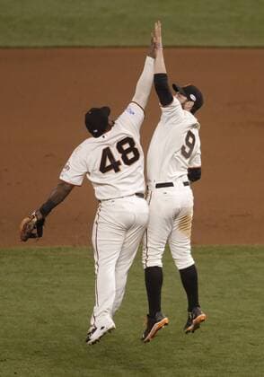 San Francisco Giants Pablo Sandoval (48) and Brandon Belt leap after shutting out the Kansas City Royals in game 5 of the World Series at AT&T Park in San Francisco on October 26, 2014. The Giants defeated the Royals 5-0.  SFP2014102612