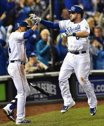 Kansas City Royals third baseman Mike Moustakas (R) high fives second baseman Omar Infante (L) after hitting a solo home run against the San Francisco Giants during the seventh inning of game 6 of the World Series at Kaufman Stadium in Kansas City, Missouri on October 28, 2014. The Giants hold a 3-2 series lead and need only one win against the Royals to win the World Series.  KCP2014102879