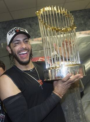 San Francisco Giants Michael Morse celebrates with the Commissioner Trophy after the Giants won the 2014 World Series, defeating the Kansas City Royals at Kaufman Stadium in Kansas City, Missouri on October 28, 2014.  WAP20141029308