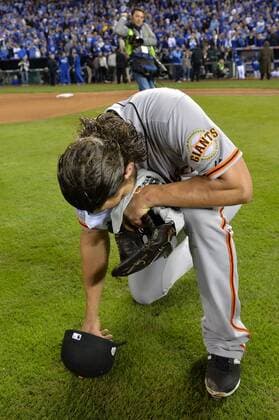 San Francisco Giants pitcher and series MVP Madison Bumgarner kneels after the final out against the Kansas City Royals in game 7 of the World Series at Kauffman Stadium in Kansas City, Missouri on October 29, 2014. San Francisco wins the World Series defeating Kansas City 3-2.  KCP20141029122